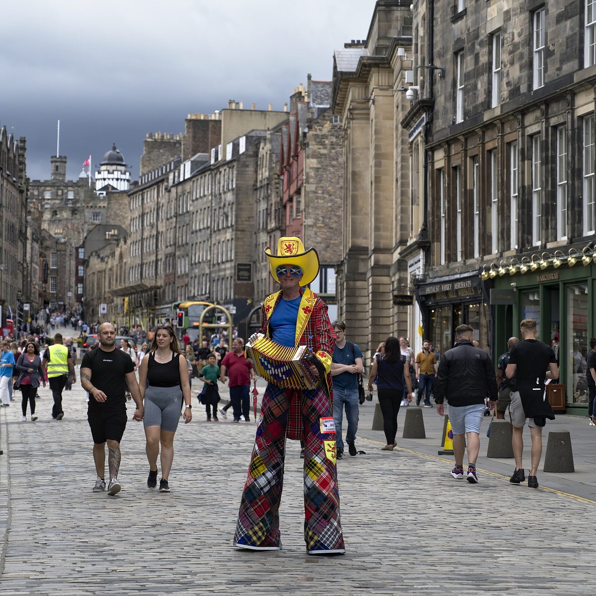 Crowds and performers on the Royal Mile during the Edinburgh Festival Fringe