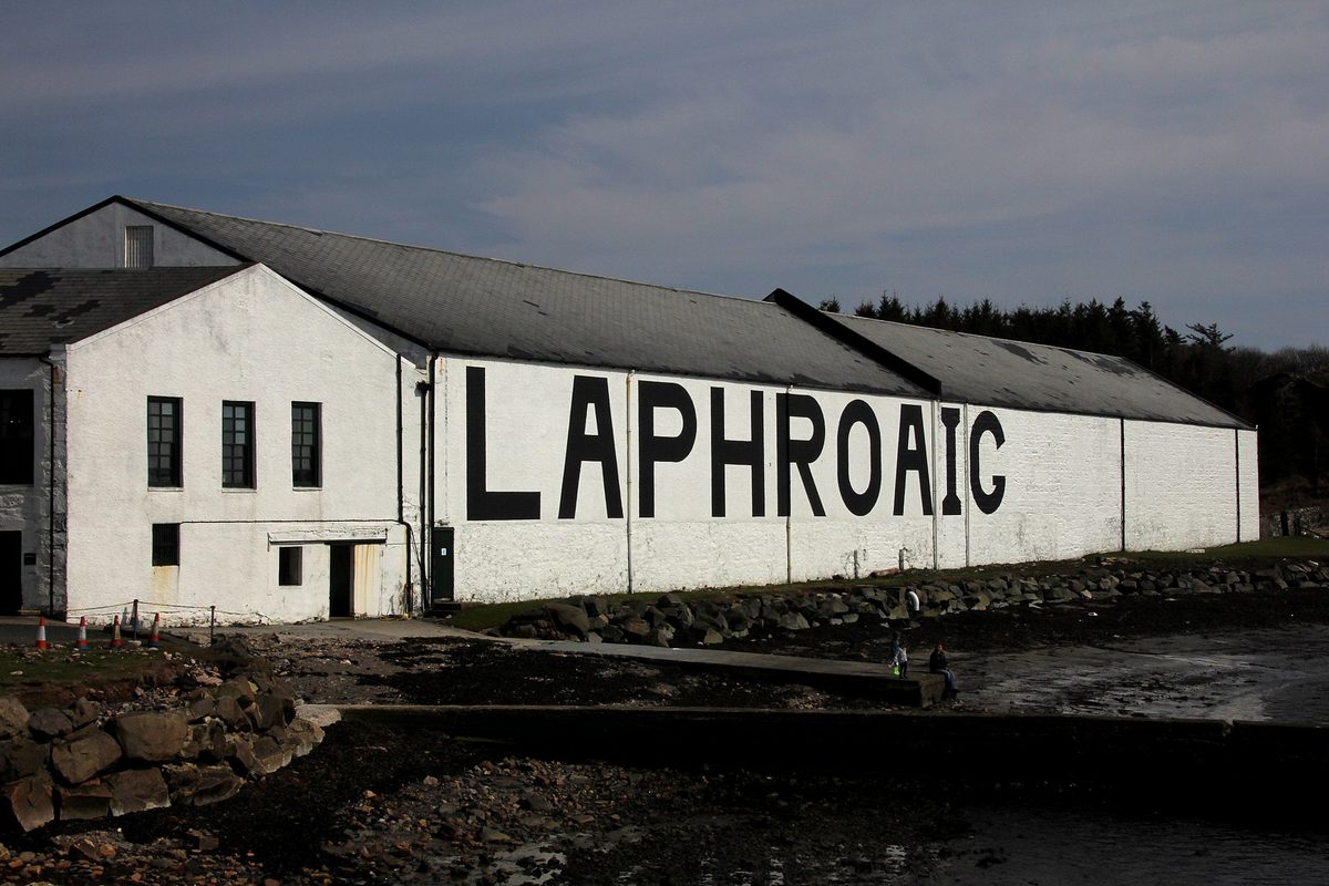White-painted Laphroaig distillery on the shore of Islay with its name in black letters