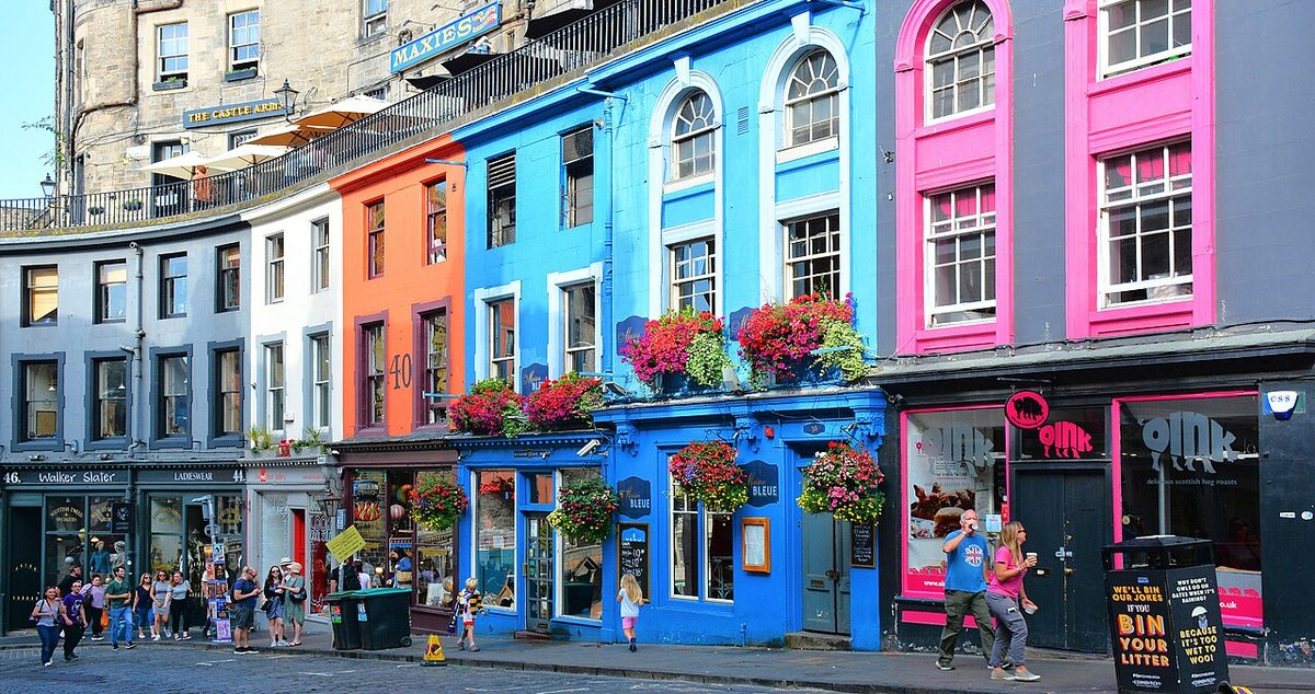 Colourful shopfronts on Victoria Street in Edinburgh's Old Town, one of the best areas to stay in Scotland for first-time visitors