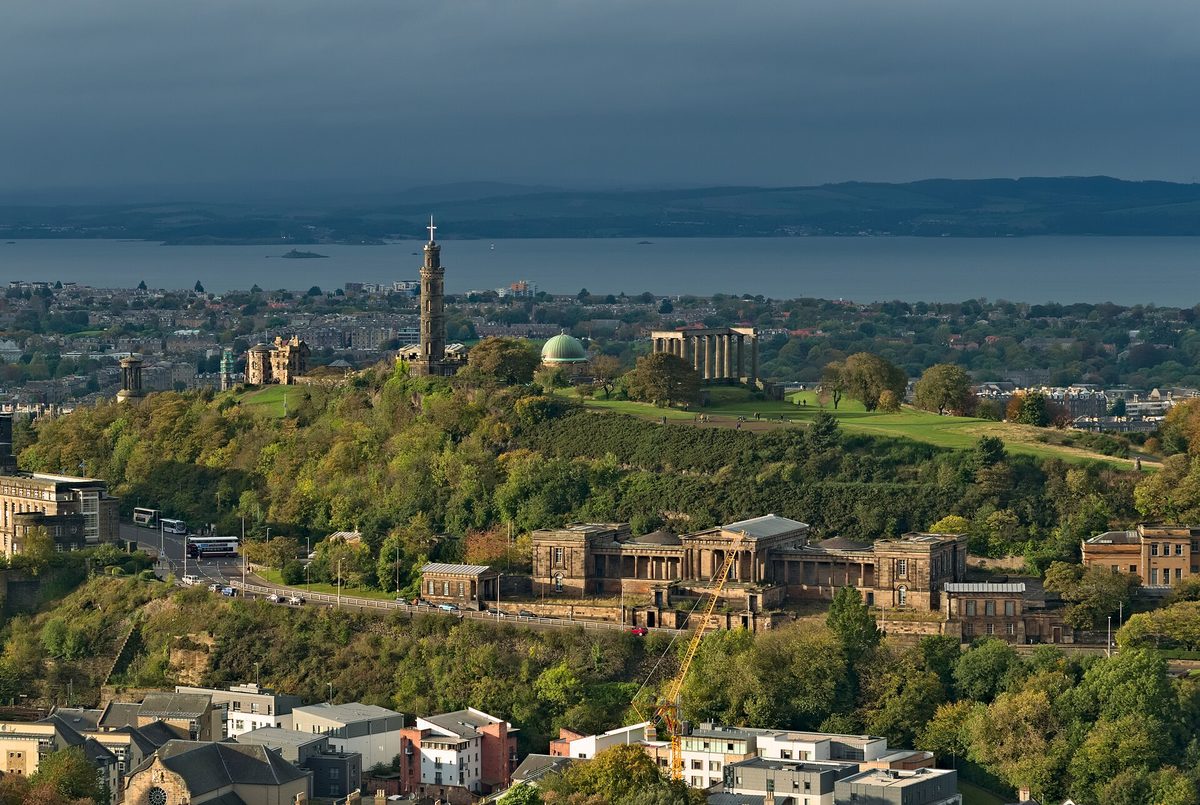 The view from Salisbury Crags across to Calton Hill, the Nelson Monument and the Firth of Forth