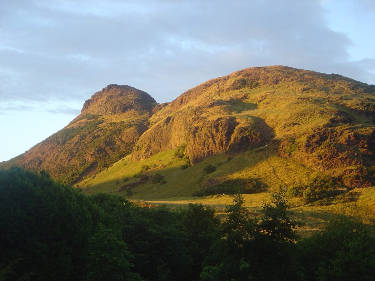 Salisbury Crags and the summit of Arthur's Seat in evening light above Holyrood Park, Edinburgh