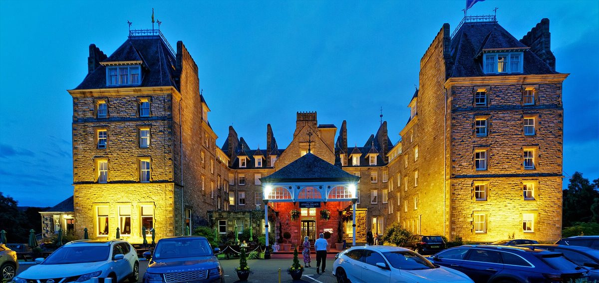 A Victorian hotel lit up at dusk in Pitlochry, the southern gateway town to the Highlands