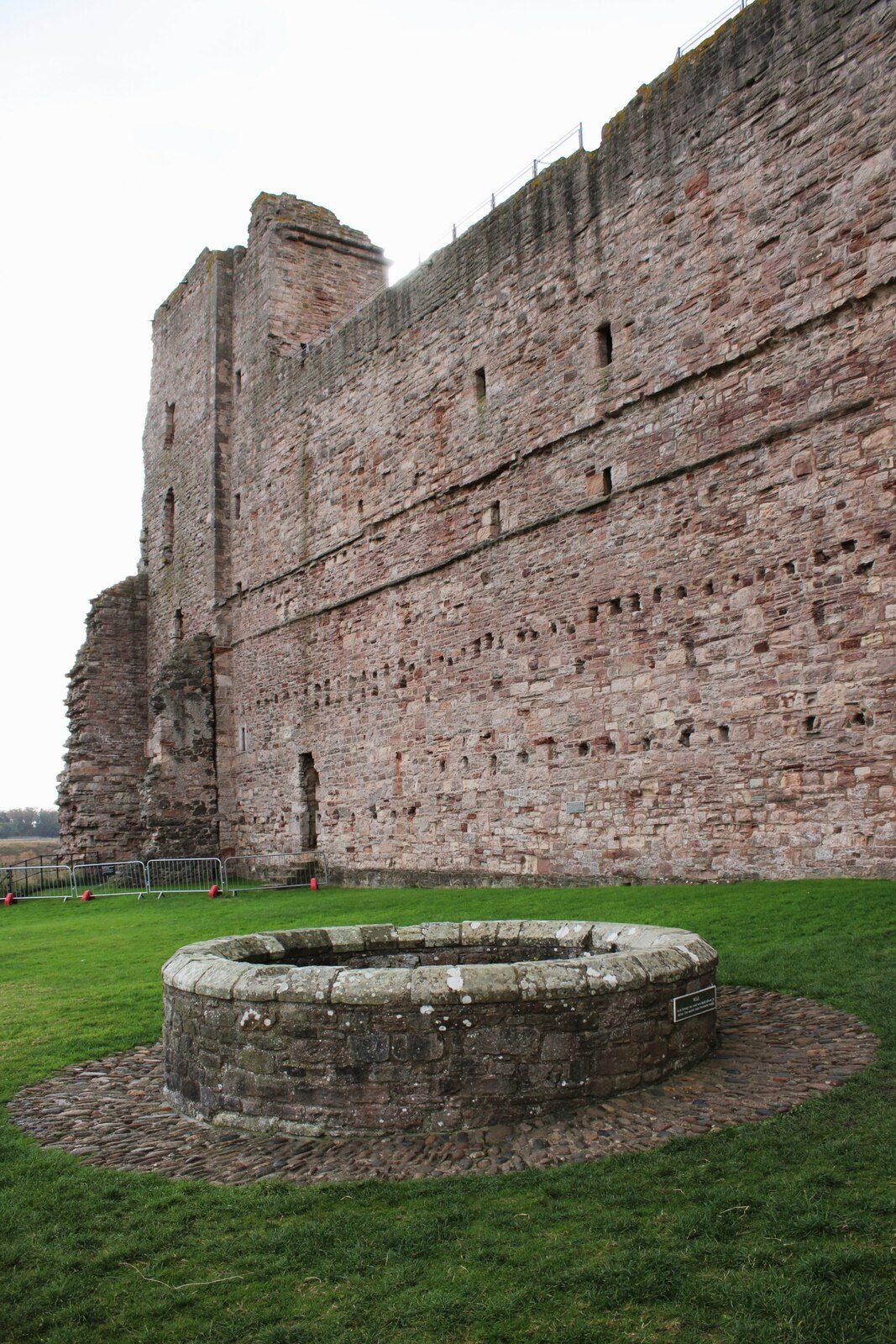 The red sandstone curtain wall of Tantallon Castle above the Firth of Forth
