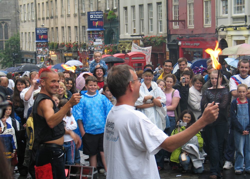 Crowds and a street performer on the Royal Mile during the Edinburgh Festival Fringe in August