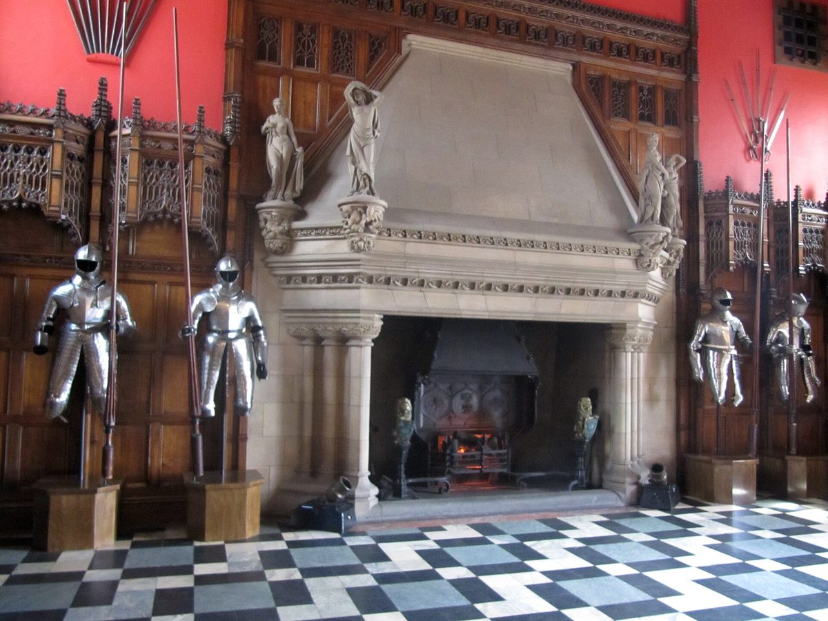 The carved fireplace and displays of arms and armour inside the Great Hall at Edinburgh Castle