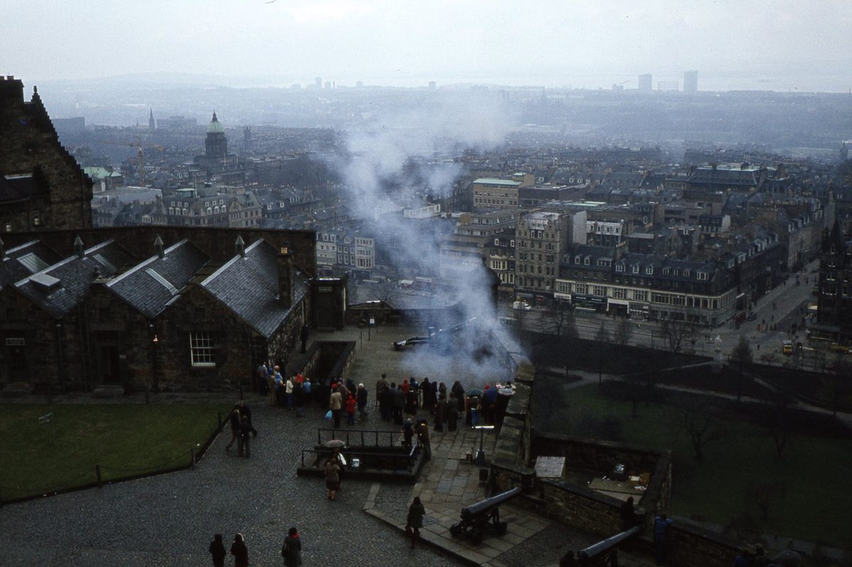 Smoke drifting over the city as the One O'Clock Gun fires from Mills Mount Battery at Edinburgh Castle