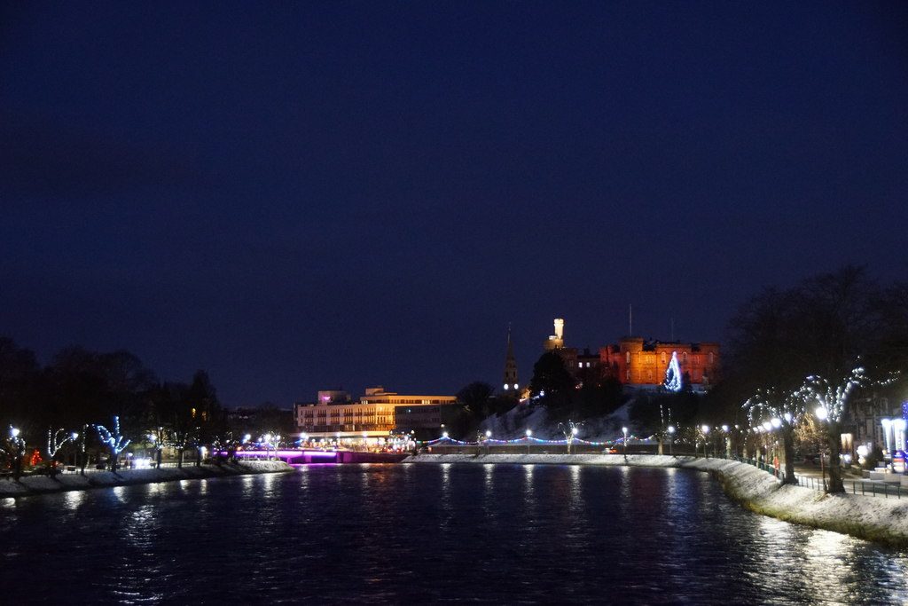 Inverness and its castle lit up above the River Ness at the end of the A9 drive