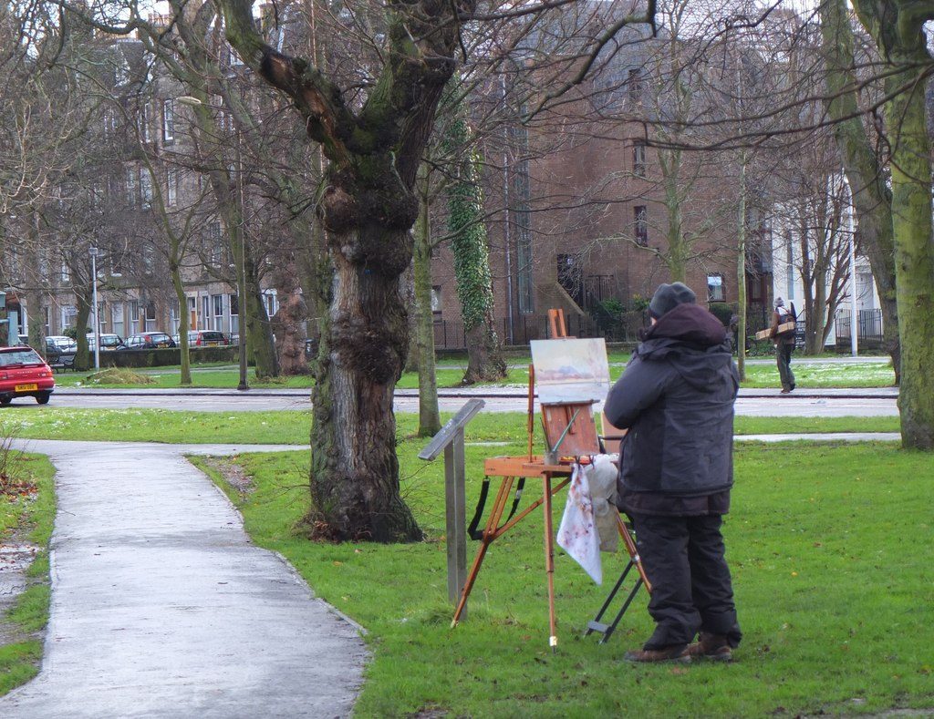 Open grass and tree-lined paths at the Meadows, a flat free park near Edinburgh's Old Town