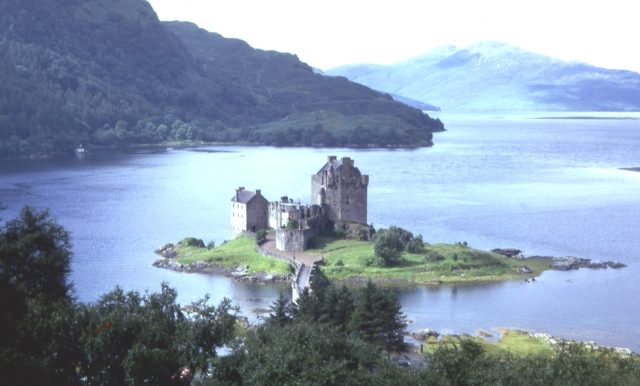 Eilean Donan Castle seen from higher ground above Loch Duich, with the island and hills behind