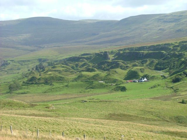 The Fairy Glen on Skye seen from across Glen Conon, a mass of green hummocks below the Trotternish escarpment