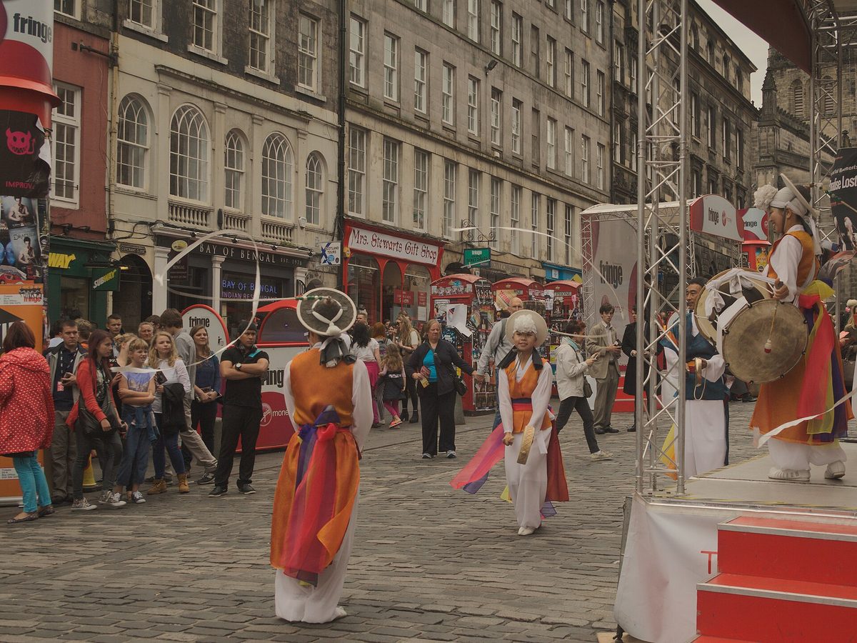 Performers and crowds at the free Fringe Street Events on Edinburgh's High Street in August