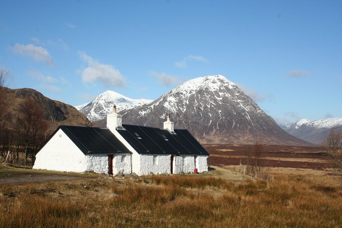 Blackrock Cottage at Altnafeadh with the snow-covered cone of Buachaille Etive Mor behind it