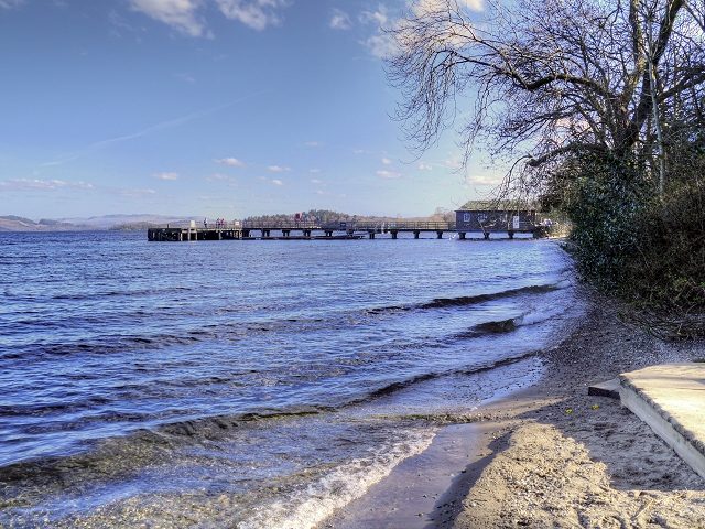 The wooden pier at Luss looking out across Loch Lomond towards Ben Lomond