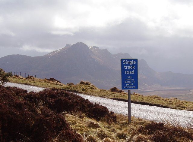 A single-track road sign on the A836 telling drivers to use passing places to permit overtaking