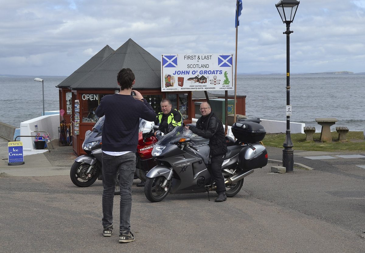 The signpost and harbour buildings at John o' Groats on the north-east corner of the NC500