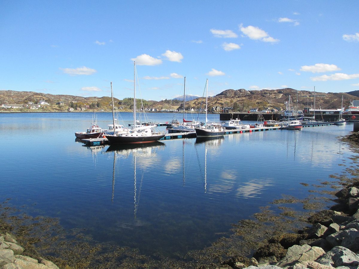Boats in Lochinver harbour in Assynt, a west coast NC500 base with limited accommodation