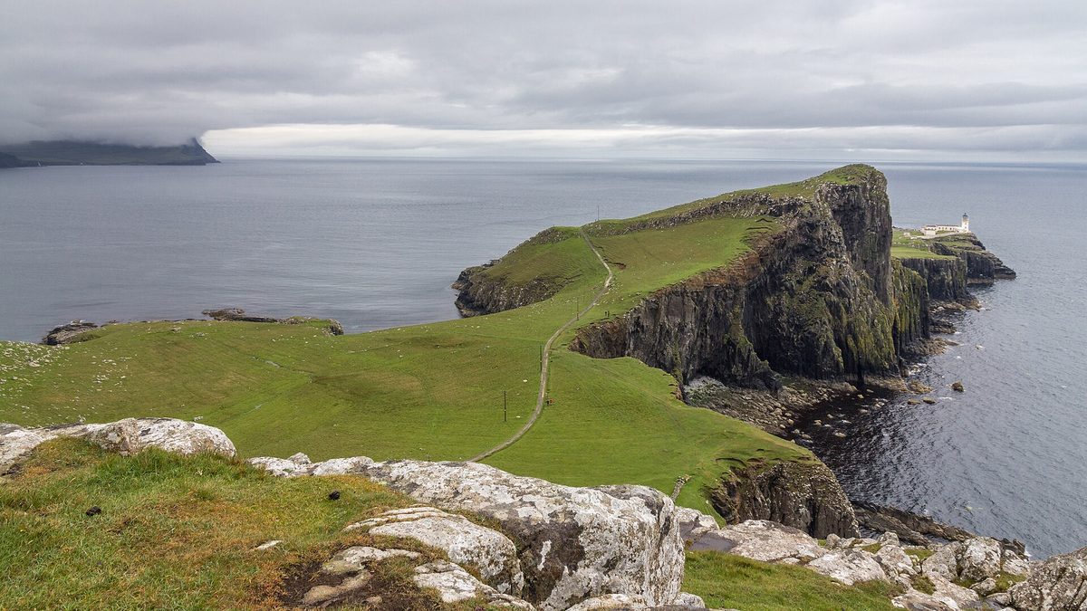 The Neist Point headland and lighthouse seen from the clifftop viewpoint above the car park