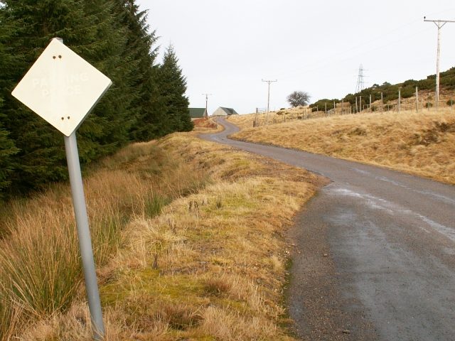 A single-track road and passing place sign in the Scottish Highlands