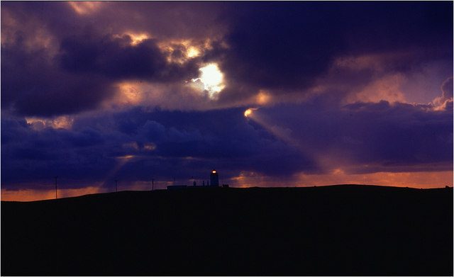 Eshaness Lighthouse on Shetland silhouetted against a stormy sky, a north-facing aurora viewpoint