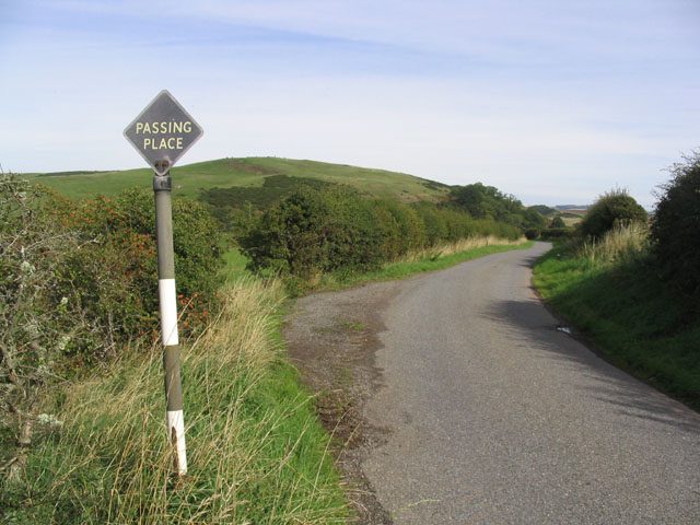 A single-track Highland road with a passing place sign