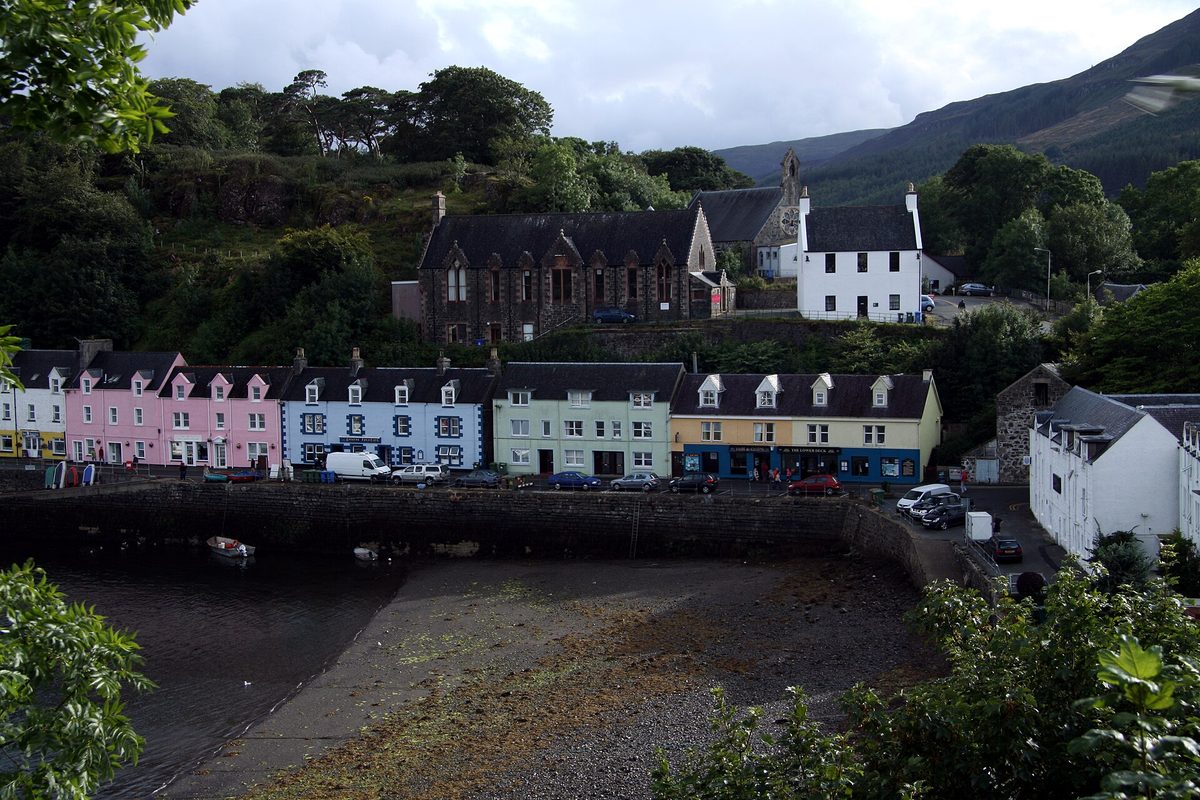 The short row of painted houses on Quay Street above the shingle beach in Portree