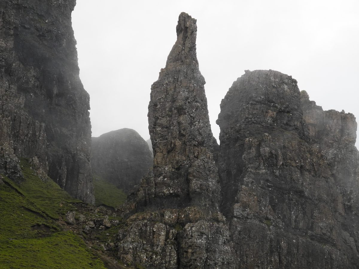 The Needle, the leaning rock spike above the Quiraing path, with cloud on the crags behind