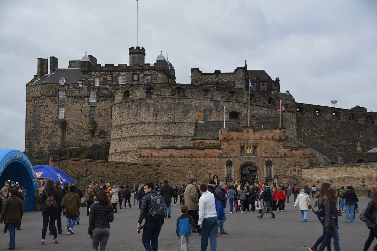 Edinburgh Castle seen from the Esplanade at the top of the Royal Mile, with visitors gathered on the parade ground