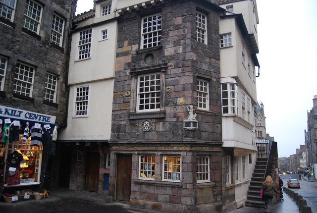 John Knox House jutting into the High Street where the Royal Mile narrows at the old Netherbow, kilt shop alongside
