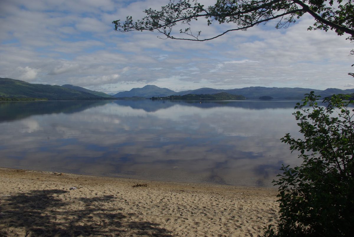 Loch Lomond on a still morning, seen from a shingle shore