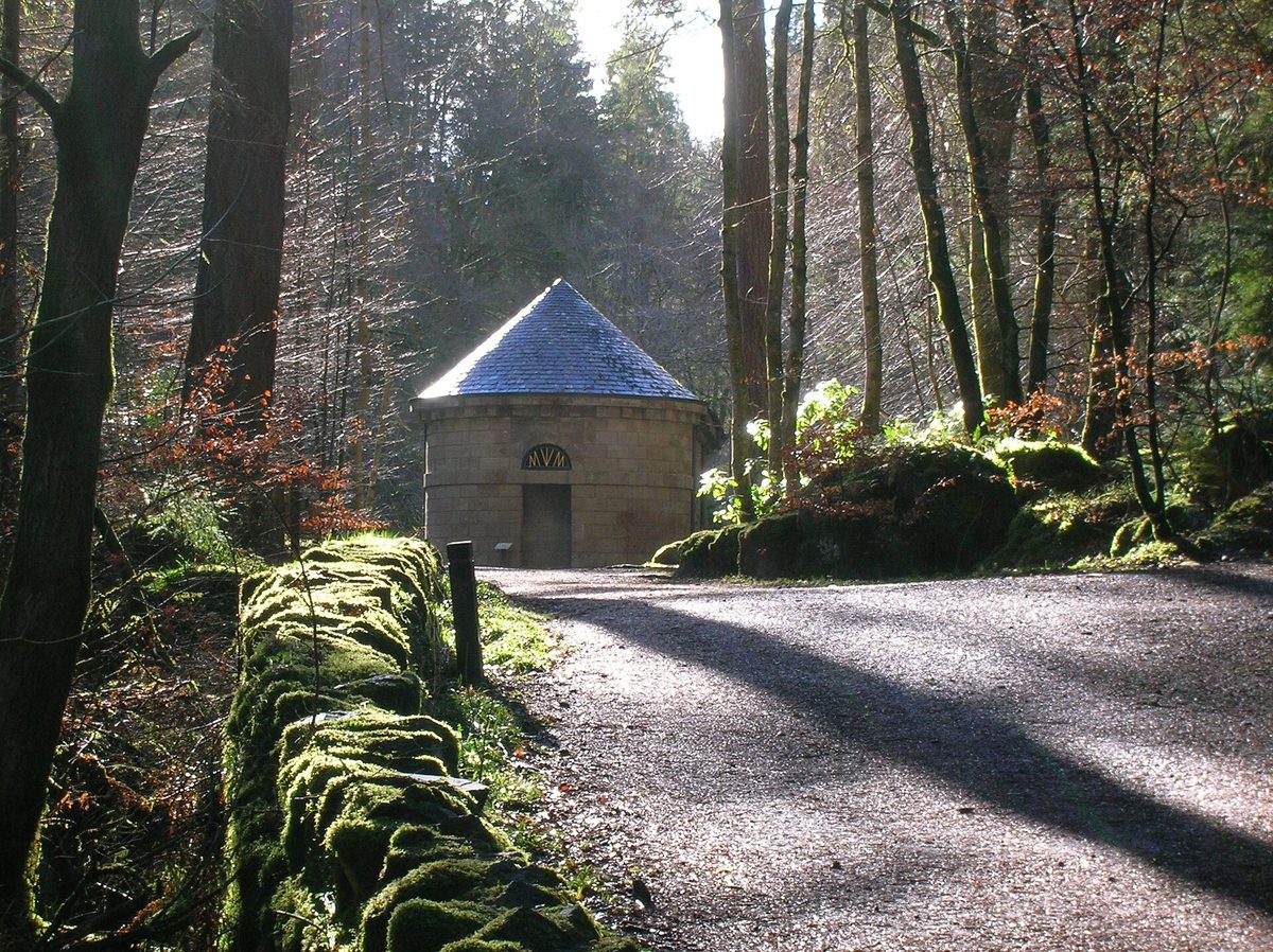Ossian's Hall and the tall conifers of The Hermitage near Dunkeld in Perthshire