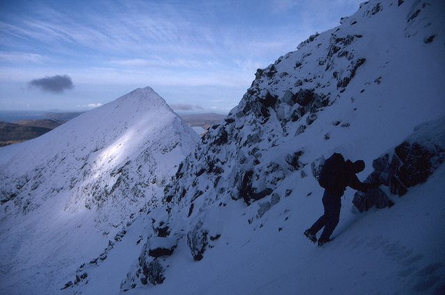A hillwalker on steep snow on Sgurr a’Mhadaidh in the Cuillin, Isle of Skye, in winter