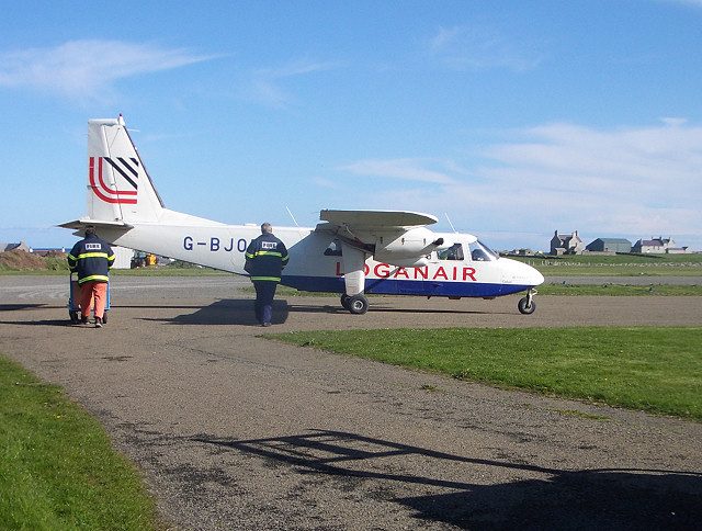 A Loganair Britten-Norman Islander on an Orkney island airstrip, the aircraft used on the world's shortest flight