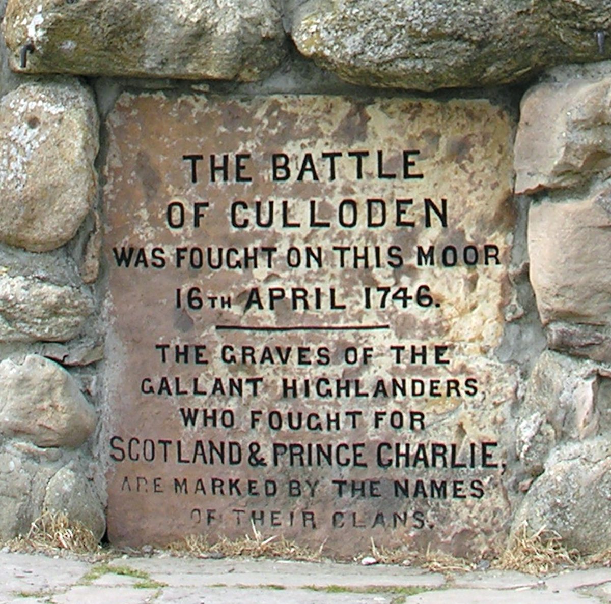 The memorial cairn inscription at Culloden, noting that the graves are marked by the names of their clans