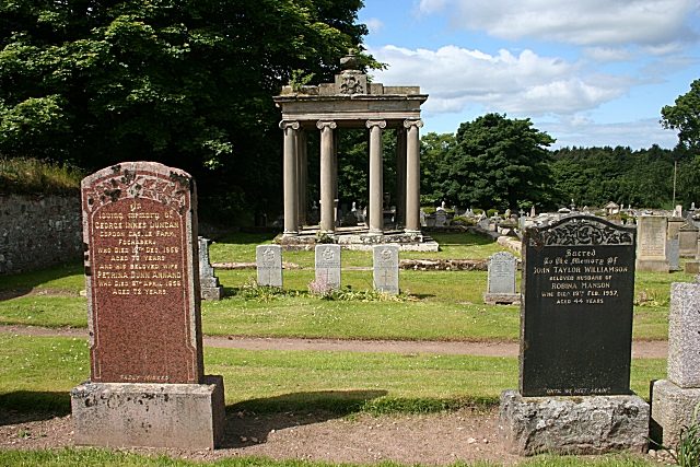 Headstones and a classical mausoleum in Bellie Kirkyard, Moray, typical of a Scottish burial ground