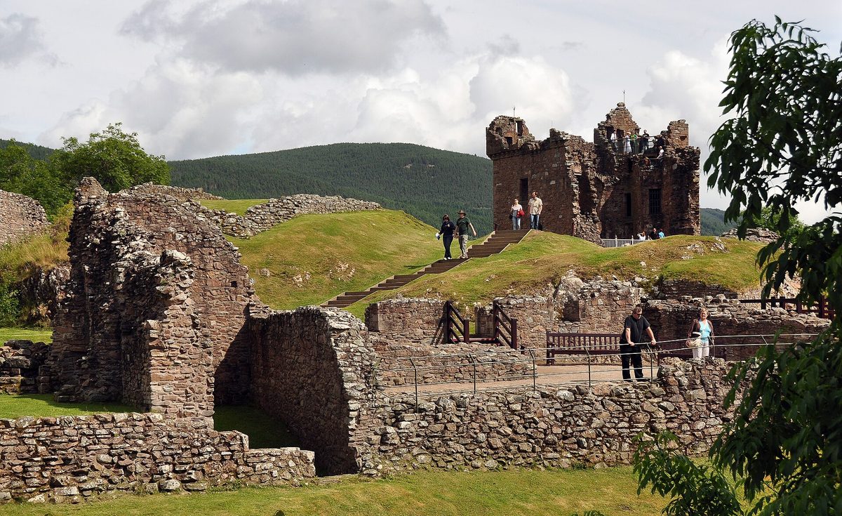 Footings and low walls of the domestic ranges at Urquhart Castle, with the Grant Tower behind